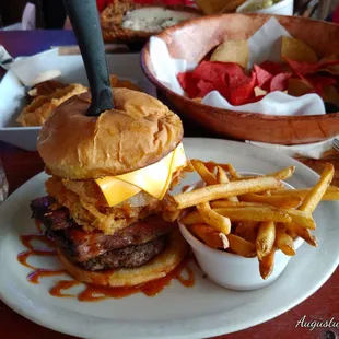 Jack Daniel Burger, big beef handmade patty with sliced brisket, and an onion ring with pickles and a side of fries
