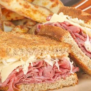 a roast beef sandwich and potato wedges