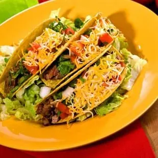 two tacos on a yellow plate