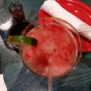 a margarita with a slice of lime on the rim