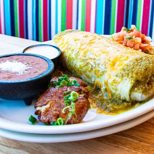 a plate of enchiladas and a bowl of salsa