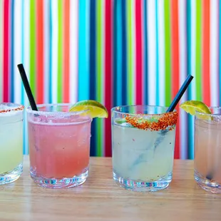 a row of cocktails on a table