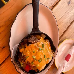 Charro Skillet: huge pieces of Carne Asada topped with hollandaise sauce and two eggs. Smoking hot and delicious!