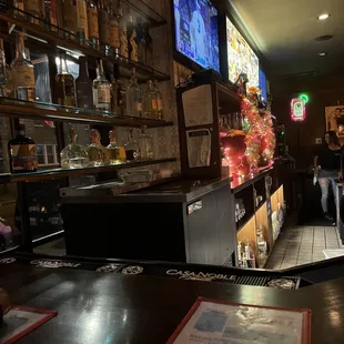 a bar with people sitting at the bar