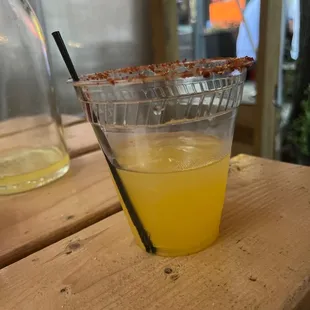 a drink in a plastic cup with a straw