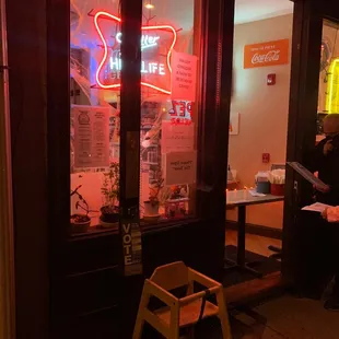 a neon sign in the window of a restaurant