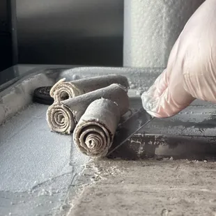 a person rolling rolled dough