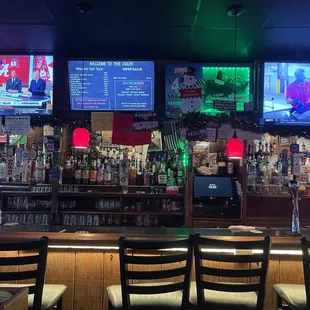 a bar with multiple televisions