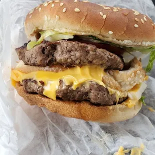 a hamburger with cheese and lettuce