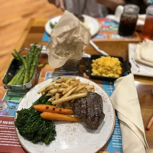 steak, fries, carrots and broccoli