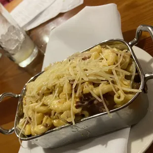 A side of Mac n cheese that comes with andouille sausage and bacon