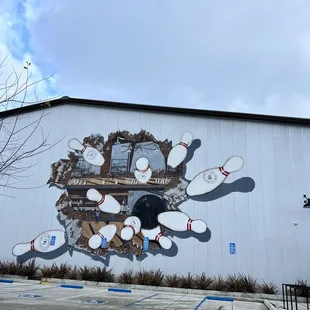 bowling pins painted on the side of a building