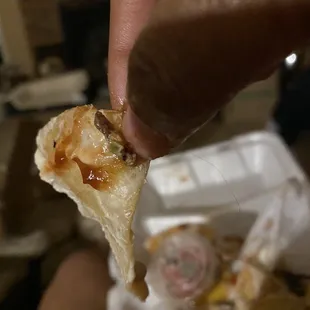 a hand holding a piece of food