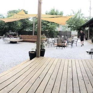a patio with tables and chairs
