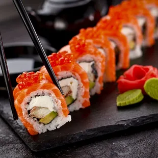 a sushi roll with salmon and avocado