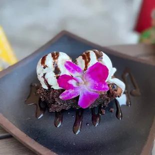 a chocolate dessert with a flower on top