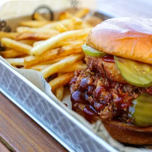 a pulled pork sandwich and french fries
