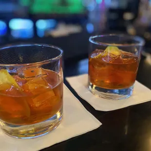 two cocktails on a bar
