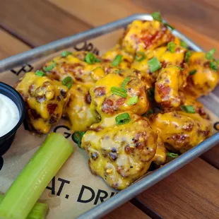 a tray of chicken wings and celery