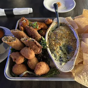a platter of appetizers and dips