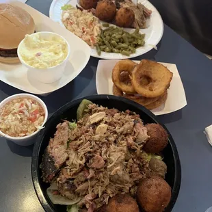 Pulled pork topped salad, awesome hush puppies, delicious onion rings, cheeseburger and great potato salad.