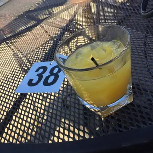 a glass of orange juice on a table