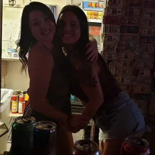 two women standing in front of a refrigerator