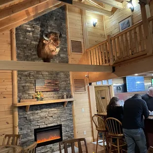 a man standing in front of a fireplace
