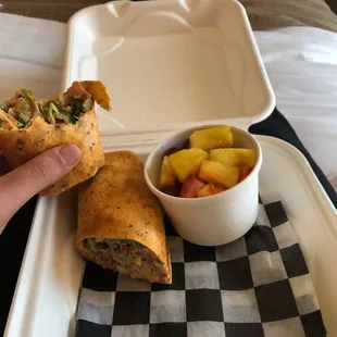 Tasty chipotle wrap, no cheese with avocado added to the mix and a side of fruit.
