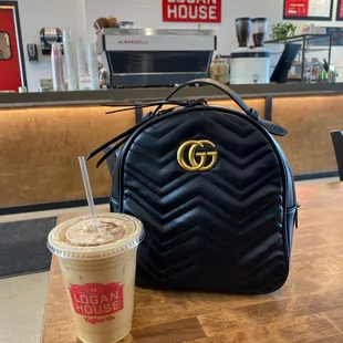 a handbag and a cup of coffee