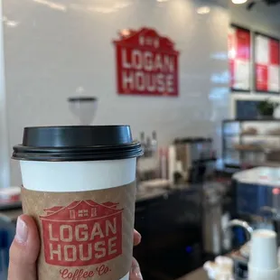 a hand holding a cup of coffee