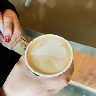 a woman holding a cup of coffee