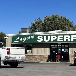 two trucks parked in front of the store