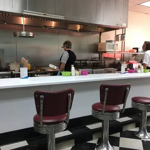 the kitchen counter and chairs