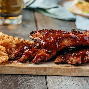 ribs and fries on a cutting board