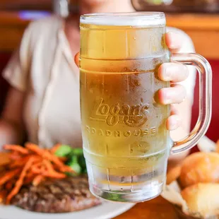 a woman holding a glass of beer