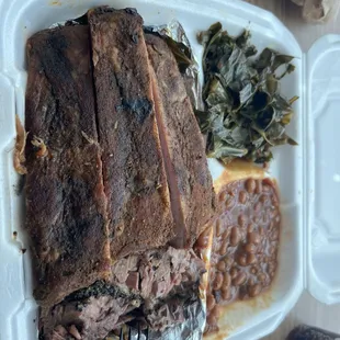 Three Meat Dinner Platter with ribs, brisket, pulled pork, beans and collards.