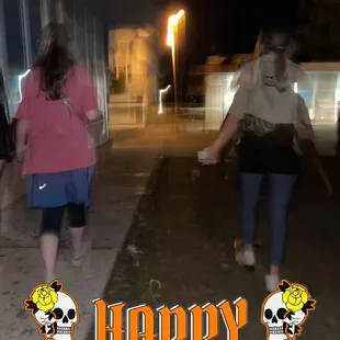 a group of people walking down a sidewalk