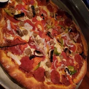 a pizza with pepperoni, mushrooms, peppers, and cheese