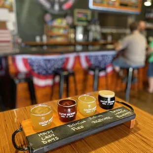 a flight of beers on a table
