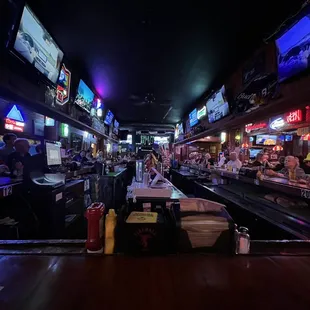The view from the end of the bar. Lots of TVs.