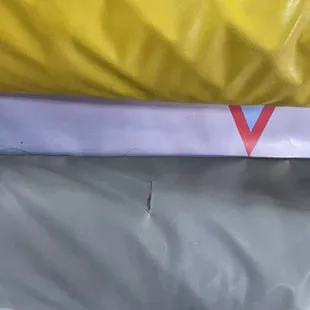 The holes/rips are where the sharp nails poke through and stab you if you step on it.