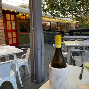 a glass of wine and a bottle of wine on a table