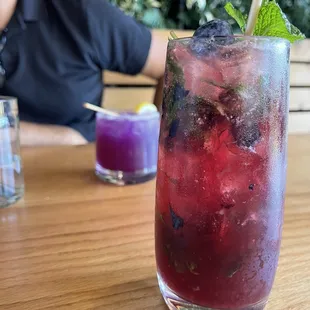 a man sitting at a table with a drink