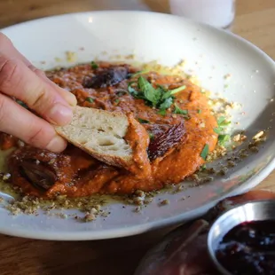 Muhammara is a roasted red pepper and walnut dip. Drizzled with extra virgin olive oil and chopped dates.