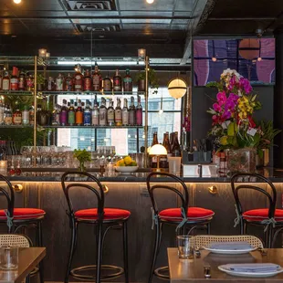 a bar with red chairs