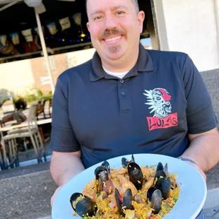 GM Carlos holding Paella