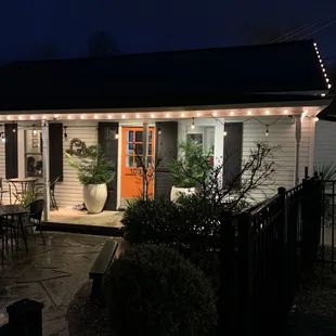 the front porch of a home at night