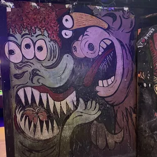 a mural of a clown and a monster