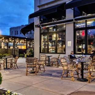 a patio with tables and chairs